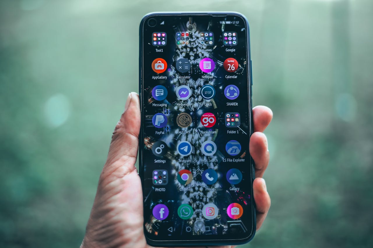 Smartphone with various apps in hand, focus on technology and connectivity.